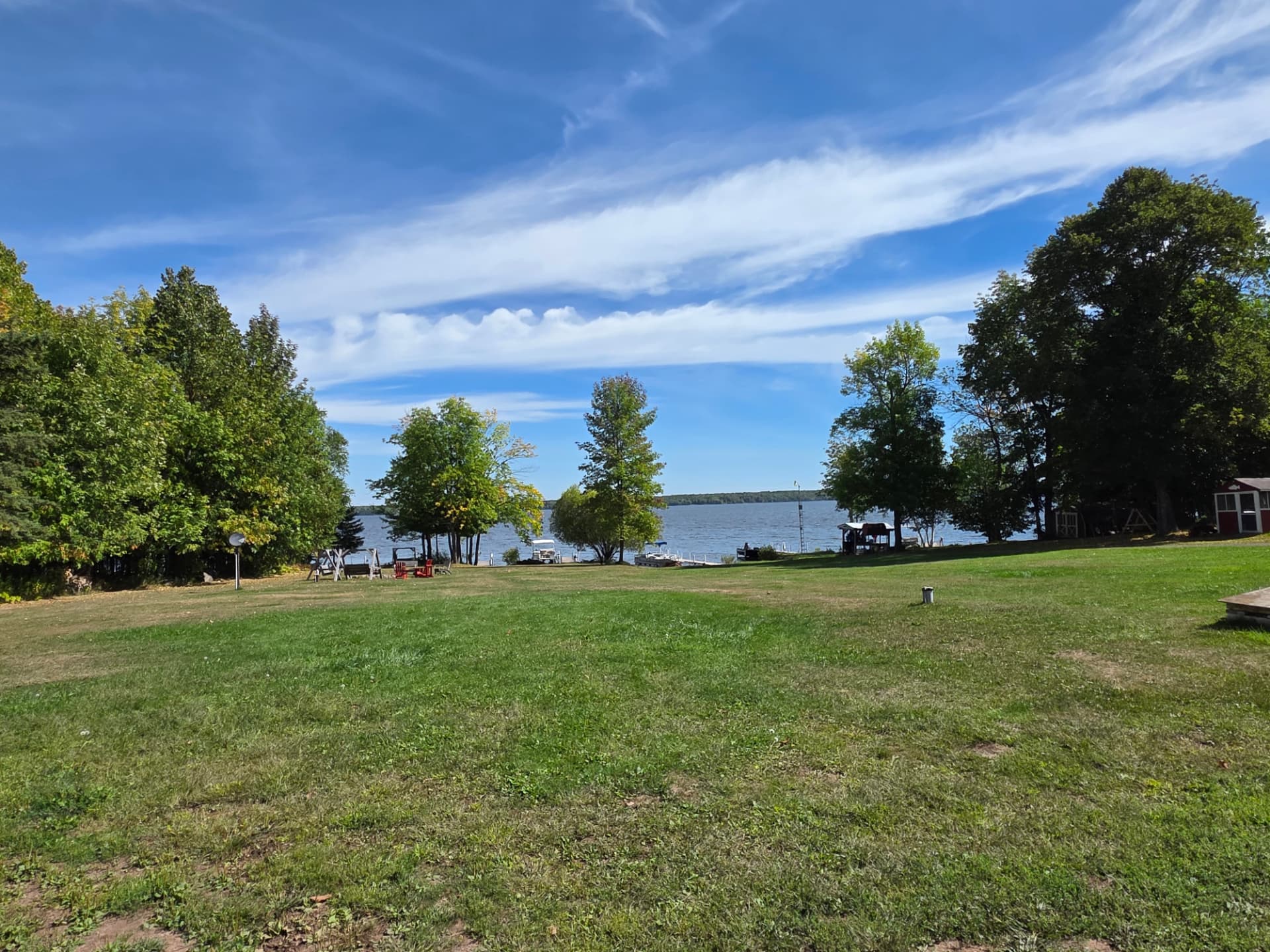 Open grassy lawn at West Shore Resort sloping down to the docks on Lake Gogebic