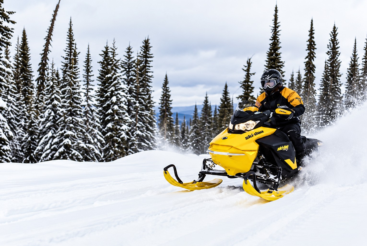 Rider on a yellow snowmobile carving through deep snow past snow-covered pines